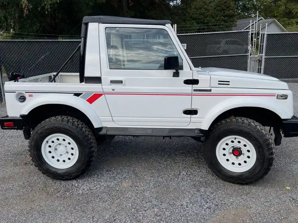 Restored Suzuki Samurai with fresh white paint, side view